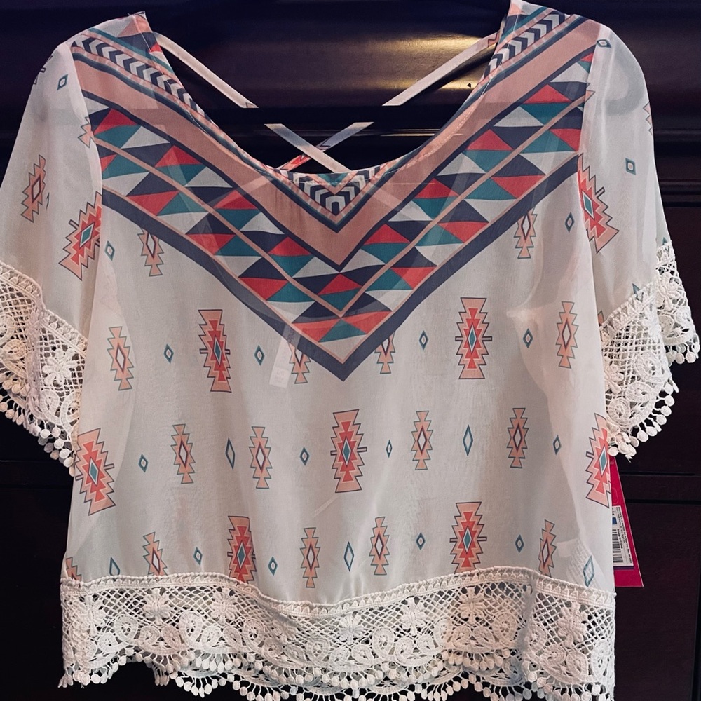 NWT Exhilaration Aztec print, cross back top with lace detail.